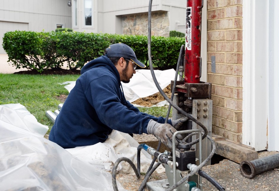 man repairing a damaged foundation